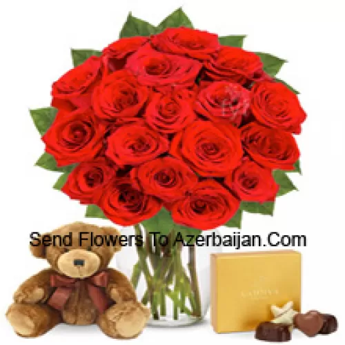 11 Red Roses With Some Ferns In A Glass Vase Accompanied With An Imported Box Of Chocolates And A Cute 12 Inches Tall Brown Teddy Bear