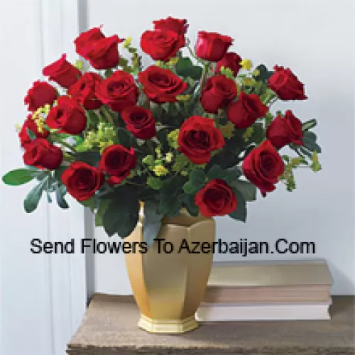 25 Red Roses With Some Ferns In A Glass Vase