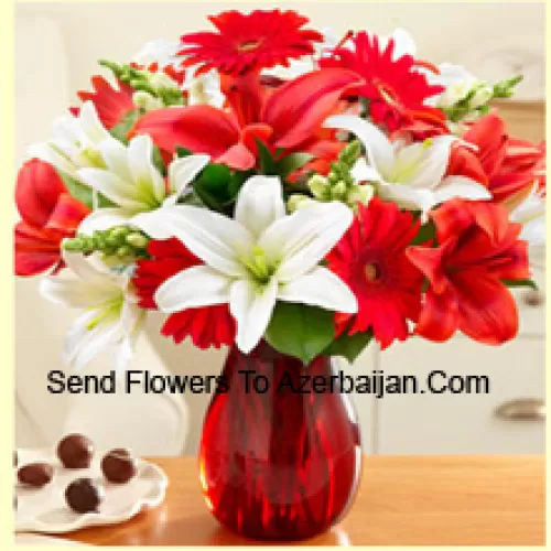 Red Gerberas, White Lilies, Red Lilies And Other Assorted Flowers Arranged Beautifully In A Glass Vase