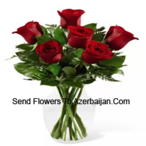 7 Red Roses With Some Ferns In A Glass Vase