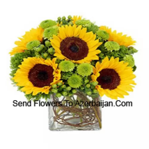 Sunflowers With Suitable Seasonal Fillers Arranged Beautifully In A Glass Vase