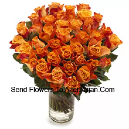 51 Orange Roses With Seasonal Fillers In A Glass Vase