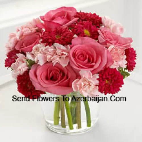 7 Pink Roses, 10 Red Colored Daisies And 10 Pink Colored Carnations In A Glass Vase