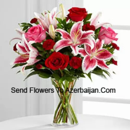 Red And Pink Roses With Pink Lilies And Seasonal Fillers In A Glass Vase